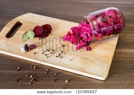 Sauerkraut With Beets And Spices In A Glass Jar On Wooden Backgr