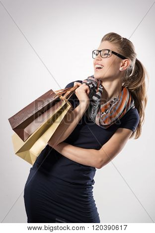 Portrait of spree shoper with shopping bags posing in studio