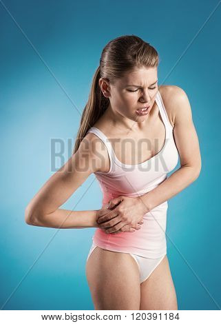 Young woman with pancreas pain over blue background