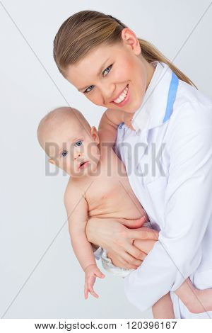 Happy smiling pediatrician/ therapist woman holding lovely child