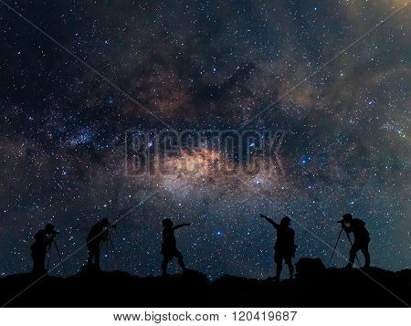 Star-catcher. A Person Is Standing Next To The Milky Way Galaxy Pointing On A Star