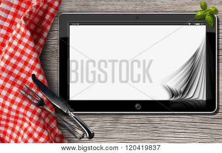 Tablet And Cutlery On A Table With Tablecloth