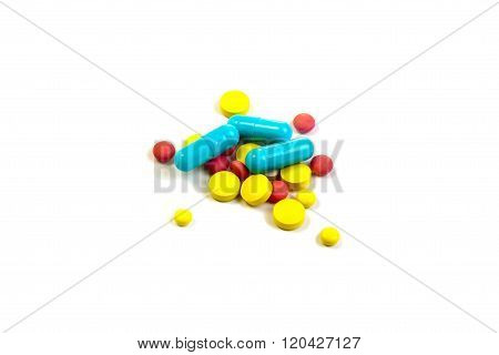 Colored Pills And Capsules On A White Background