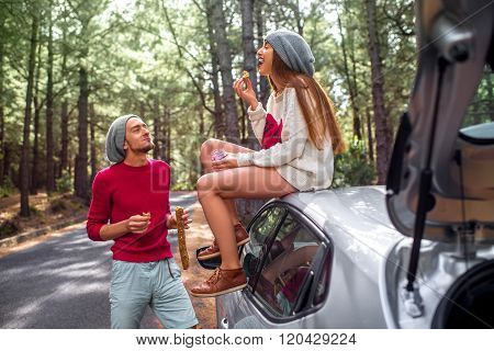 Young couple traveling by car in the forest