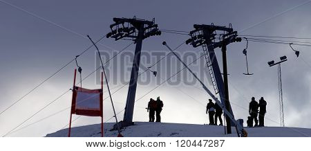 Silhouette Of A Ski Lift And And Skiers In Evening Light