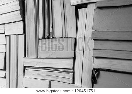 Stack of used old books on bookshelf