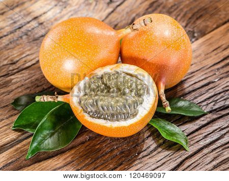 Granadilla fruits on the wooden table.