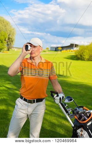 man golfer watching into rangefinder