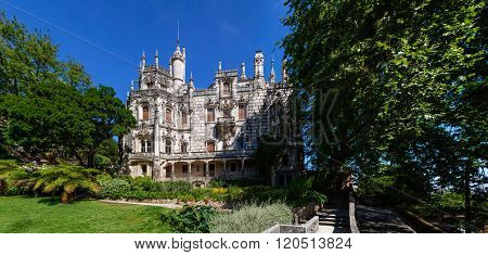 Sintra, Portugal - July 14, 2015: Regaleira Palace facade and Gardens. A neo-manueline palace decorated with alchemy and freemasons symbols.