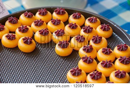 Kanom sanay chan made from minced coconut mixed with flour, sugar, egg yolk, rice flour and chan herb
