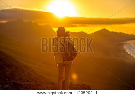 Woman photographing Fuerteventura island