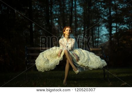 Pretty Bride On Bench In Forest