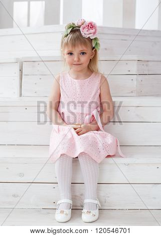Portrait Of A Little Blonde Girl In A Flower Wreath