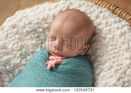 Sleeping Newborn Baby Boy Swaddled In Blue