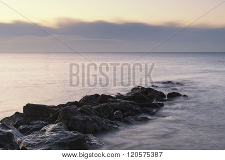 Stunning Sunrise Landscape Over Rocks In Sea