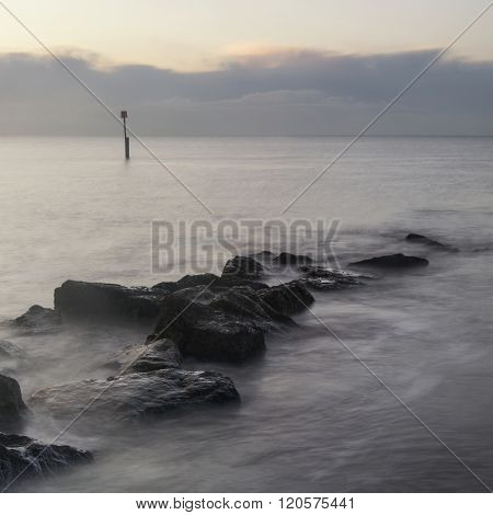 Stunning Sunrise Landscape Over Rocks In Sea