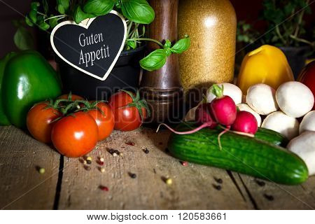 A Lots Of Healthy Vegetables On A Wooden Table, Heart With Text Guten Appetit