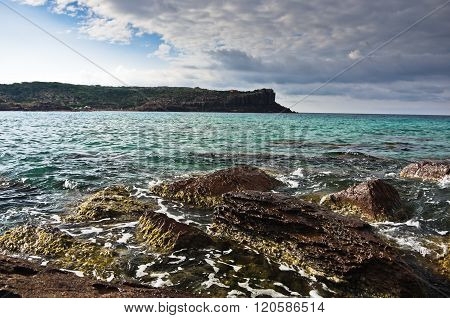 Sea rocks and waves at beach in San Pietro island, Sardinia