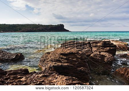 Sea rocks and waves at beach in San Pietro island, Sardinia