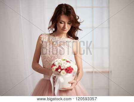Bride in a pink dress with flowers