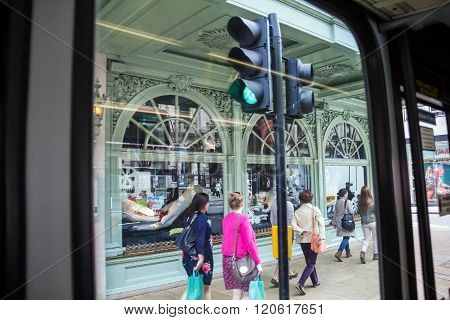 LONDON UK - JUNE 6 2015: Unidentified people in Piccadilly street . View from bus windiw. The city is visited by more than 30 million people every year.