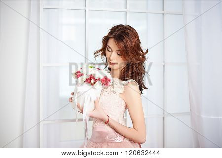 Bride in a pink dress with flowers
