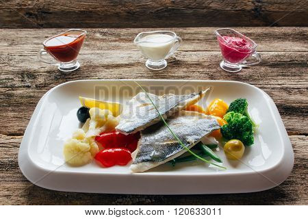 Stewed dorado fillet with vegetables and sauces