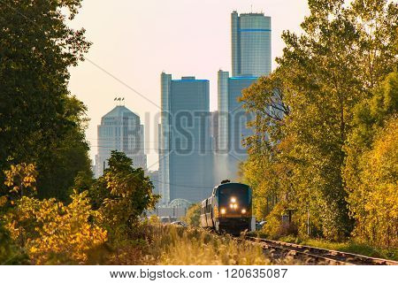 Passenger Train Leaving City In Summer