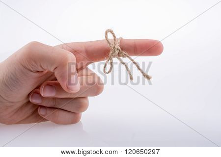Hand tied with a thread like a ribbon on a white background
