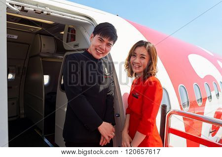 PATTAYA, THAILAND - FEBRUARY 26, 2016: crew members meet passengers of Thai AirAsia. Thai AirAsia is a joint venture of Malaysian low-fare airline AirAsia and Thailand's Asia Aviation