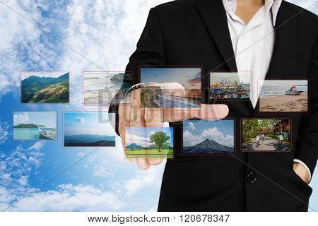 Businessman choosing photo, on digital touchscreen, travel concept and flashback to the past concept