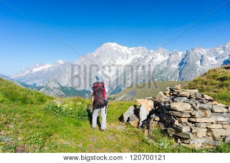 Backpacker Hiking On The Alps, Majestic Mont Blanc In Background