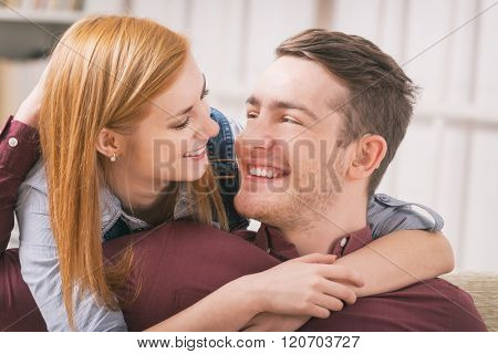 Smiling young woman loving her hearing impairment man