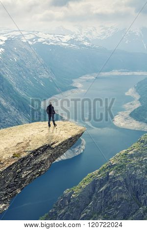 Woman On Trolltunga - 
View On Norway Mountain Landscape From Trolltunga - The Troll's tongue in Odda, Ringedalsvatnet Lake,  Norway).