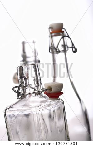 Empty glass bottles on a white background selective focus on foregound