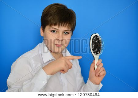 Boy teenager with a comb in his hand