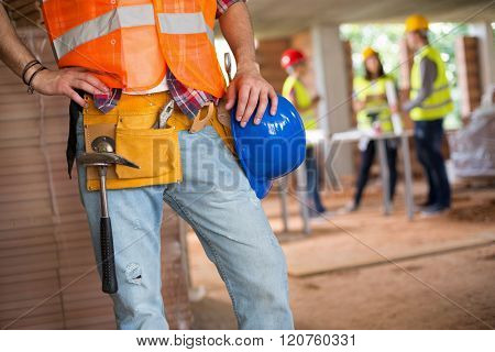 Young construction workman communicate with walkie talkie