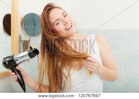 Long Haired Woman Drying Hair In Bathroom