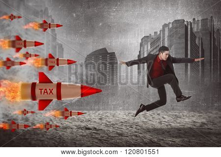 Asian Business Man Jump From Tax Rocket