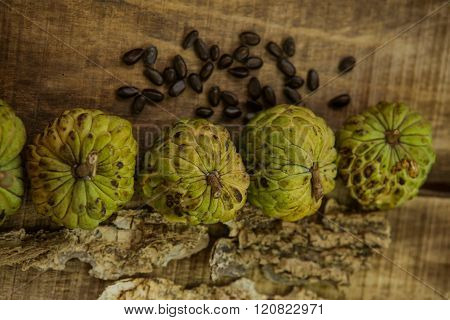 Ripe Sugar-apple Seeds By Unbroken Fruits On Wooden Table