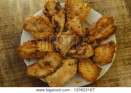 Top View Fried Pieces Of Chicken Lying On White Plate