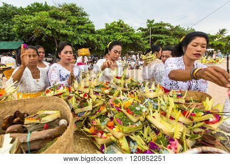 SANUR, BALI - MAR 18, 2016: Unidentified local people during performed Melasti Ritual. Melasti is a Hindu Balinese purification ceremony and ritual is held several days prior to the Nyepi holy day.