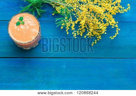 Glass Of Fruit Smoothies, And Nearby Are The Flowers Of Mimosa
