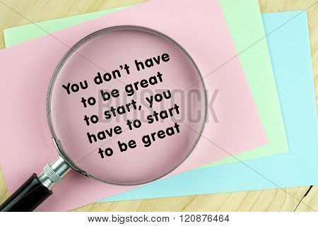 Magnifying glass on papers with inspirational words