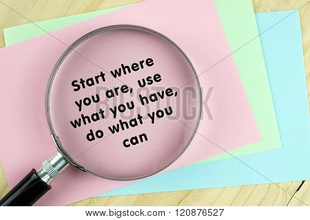 Magnifying glass on papers with inspirational words