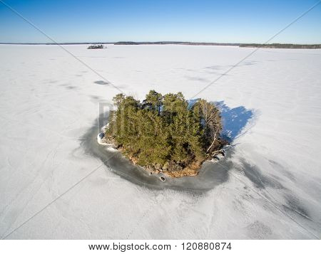 Island surronded by ice on a frozen lake