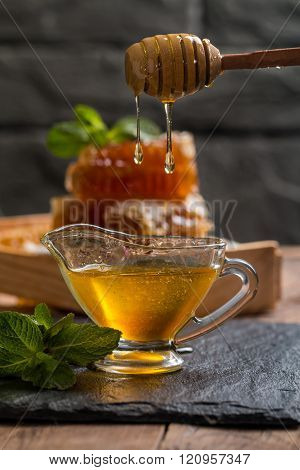 Honey Dripping From A Wooden Honey Dipper