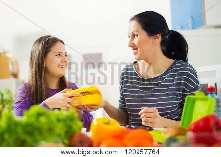 Mother Making Breakfast For Her Children In The Morning And A Snack For School