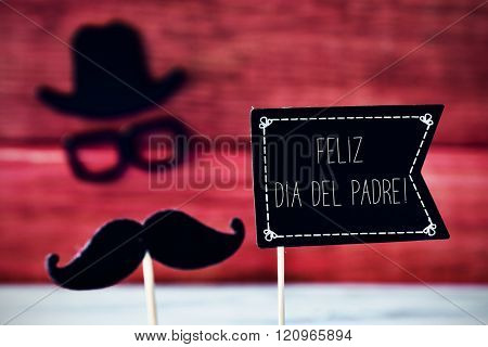 a black flag-shaped signboard with the text feliz dia del padre, happy fathers day in spanish, and a mustache, a pair of eyeglasses and a hat forming the face of a man