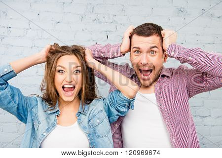 Close Up Photo Of Angry Man And Woman Touching Their Heads